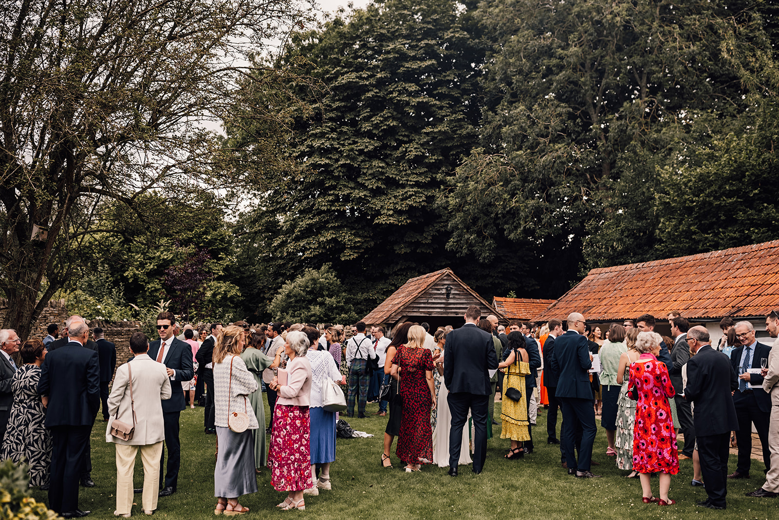 Wedding guests gathered on the lawn at an Oxfordshire wedding